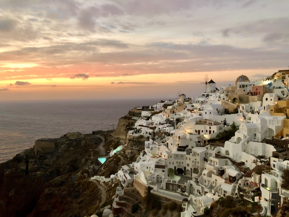 Sunset view over Santorini with white Cycladic houses.