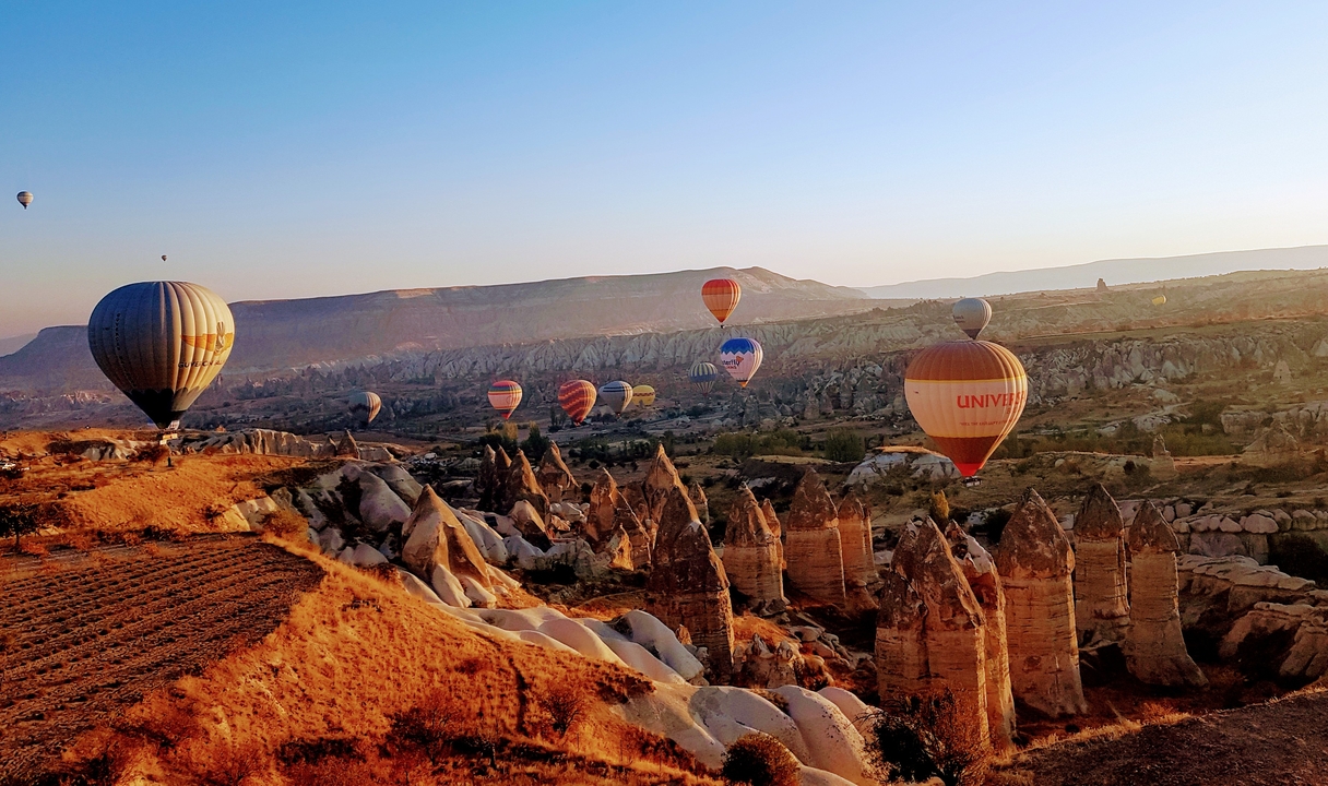 Hot air balloons floating over Cappadocia's unique landscape.