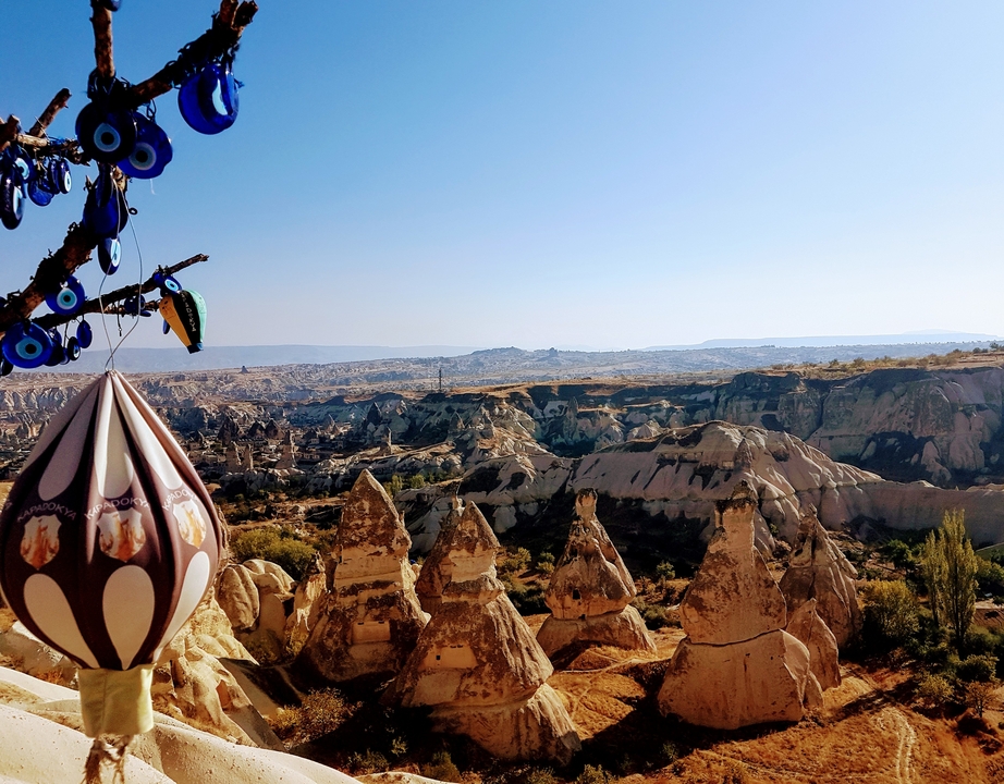 View over Cappadocia with decorative objects hanging in the foreground.