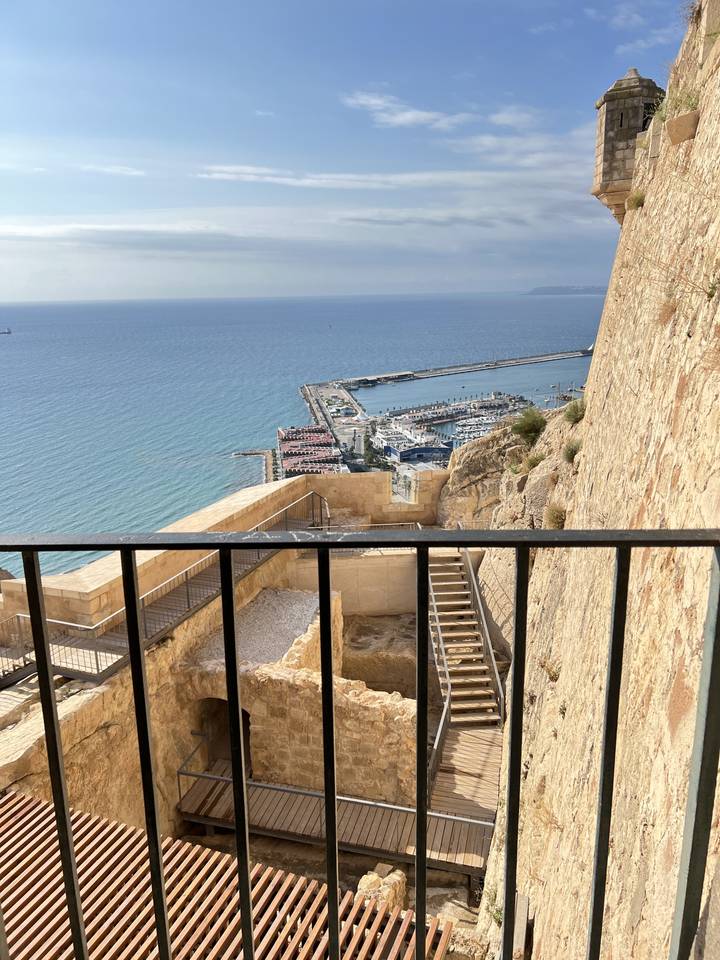 Castle overlooking a harbor with ocean views.