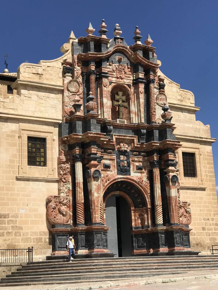 An ornate architectural facade with a person standing nearby.