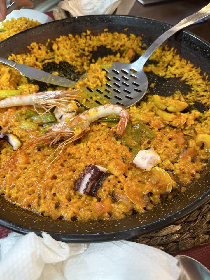 Close-up of a decorated paella dish.