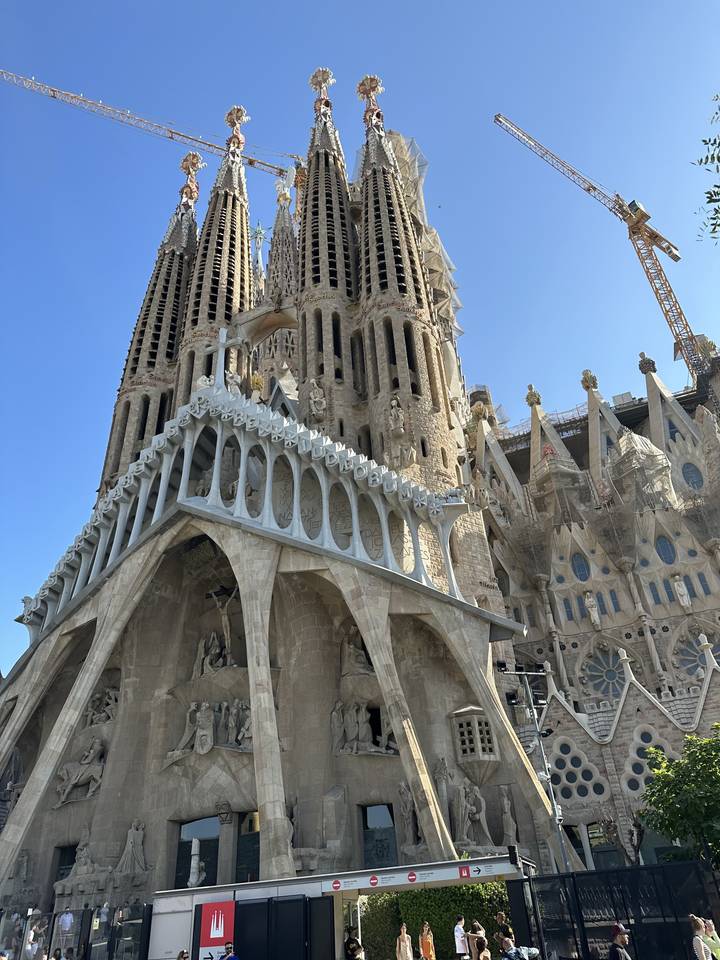 Iconic basilica facade with tourists taking pictures.
