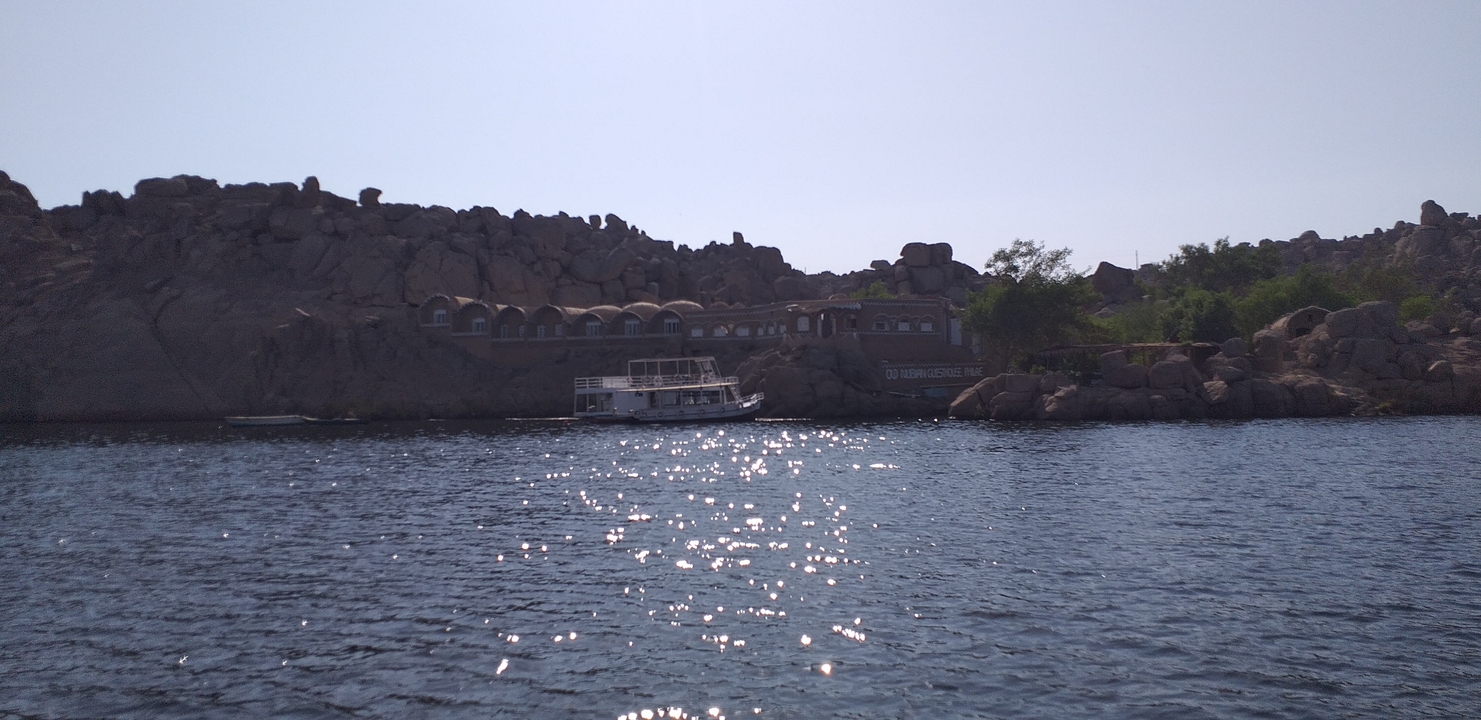Rocky landscape with a boat on the water during the day.