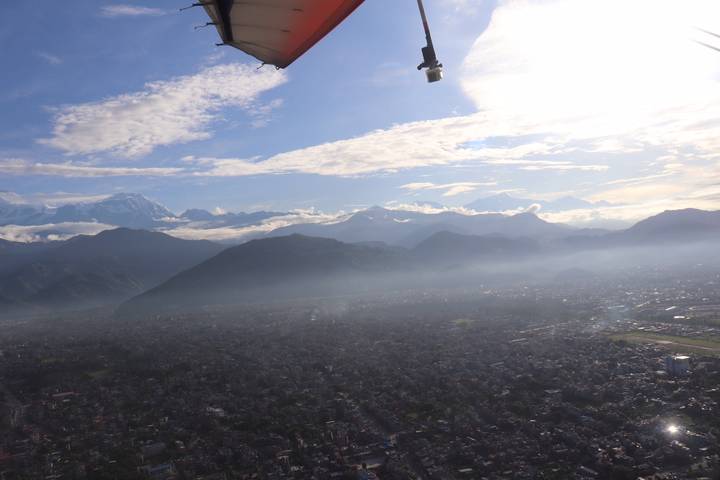 Vue aérienne d'une vallée urbaine entourée de montagnes.