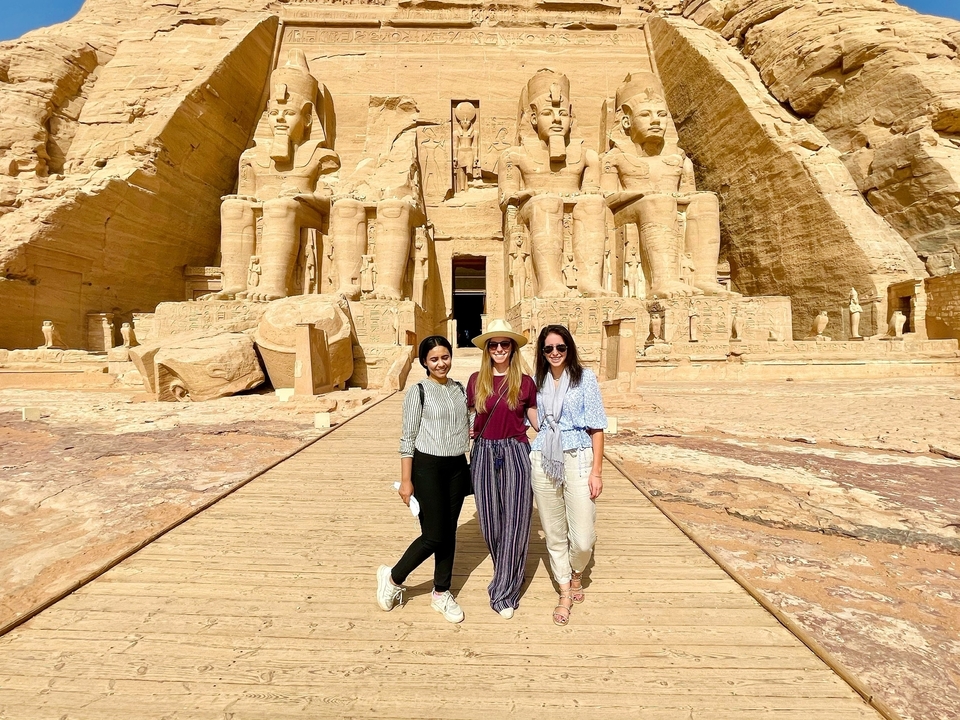 Three people posing in front of Abu Simbel temple.