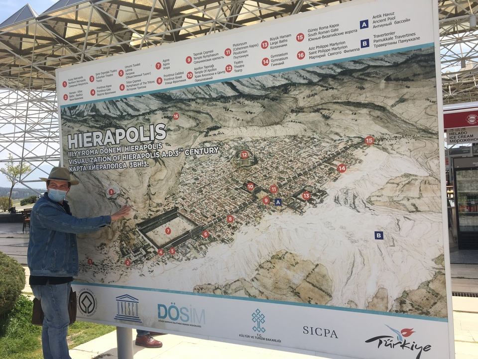Map of Hierapolis with a person pointing at the site.