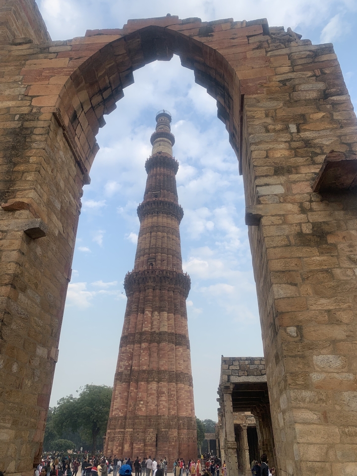 Tall ancient tower viewed through an archway.