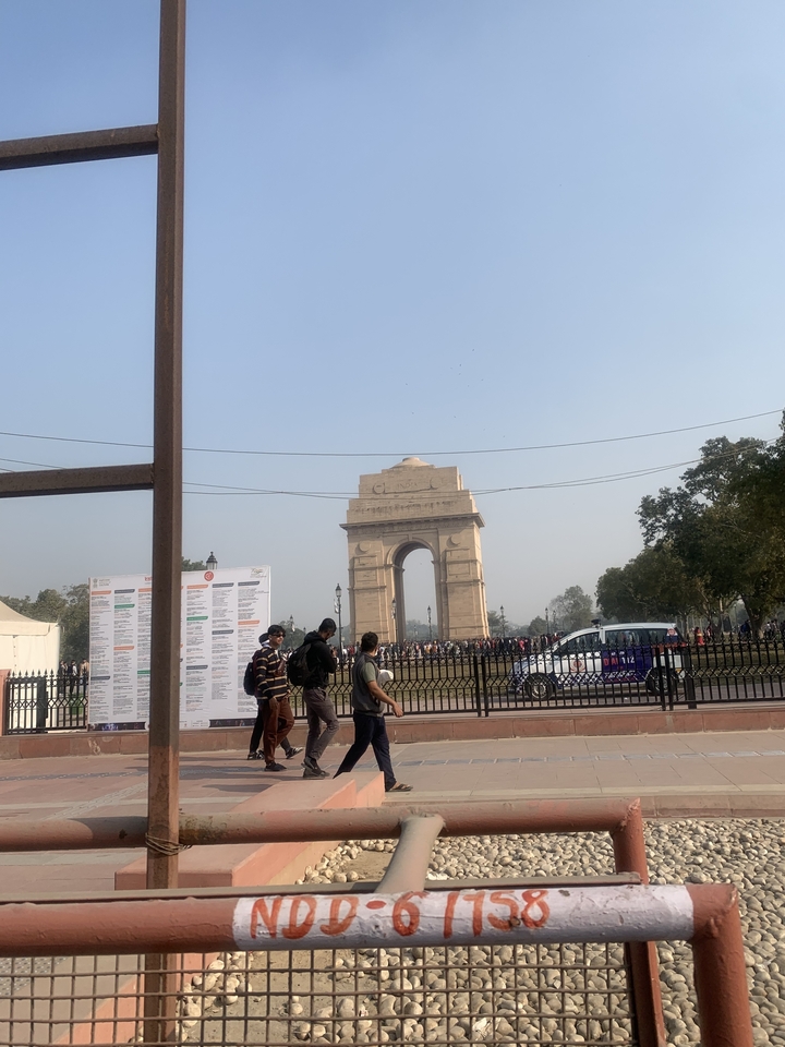 India Gate with tourists and a vehicle