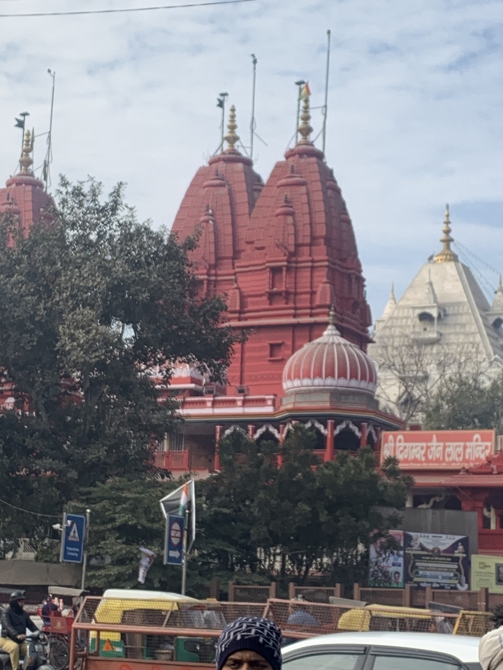 Colorful Indian temple architecture with trees in the foreground