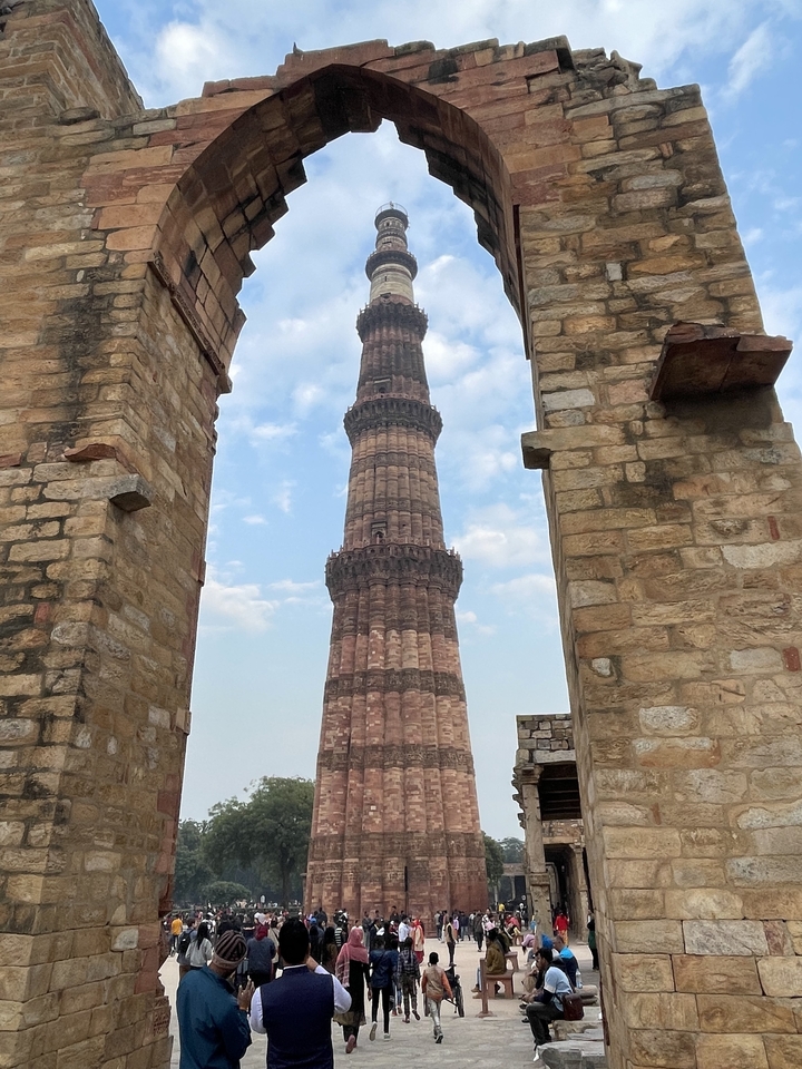 Tall ancient tower viewed through an archway.