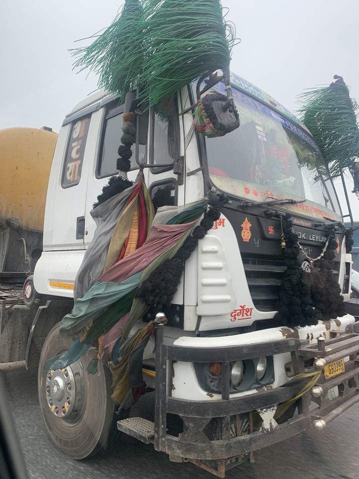 Decorated truck front with vibrant fabrics.