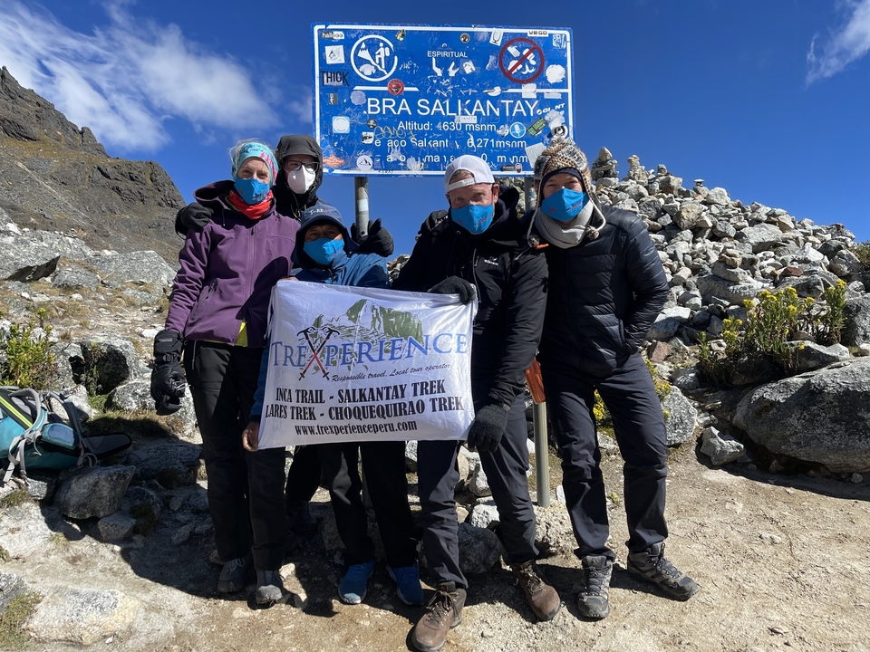 Group of trekkers at Salkantay, holding a banner.