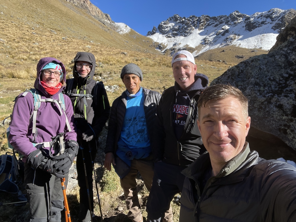 Group of hikers in outdoor gear, posing for a photo.