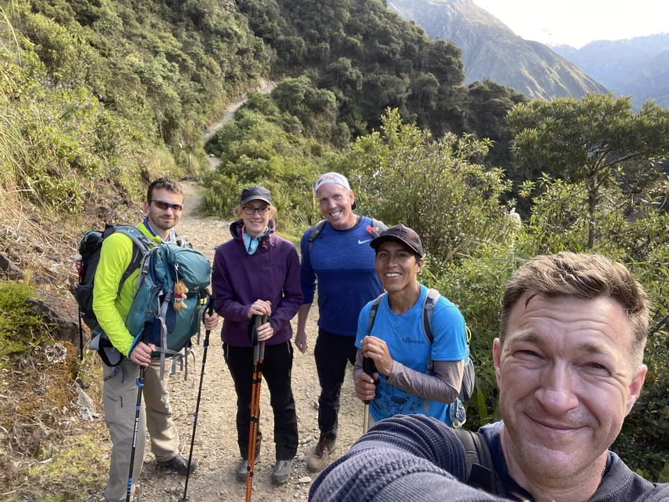 Group of hikers standing on a trail in the mountains.