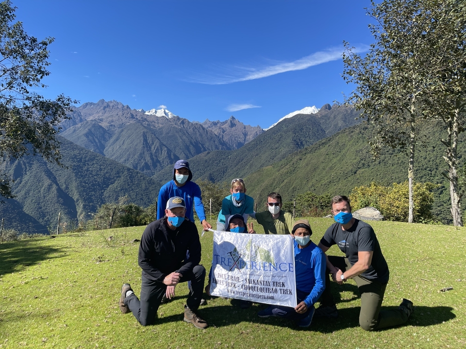 Group of people posing with scenic mountain view.