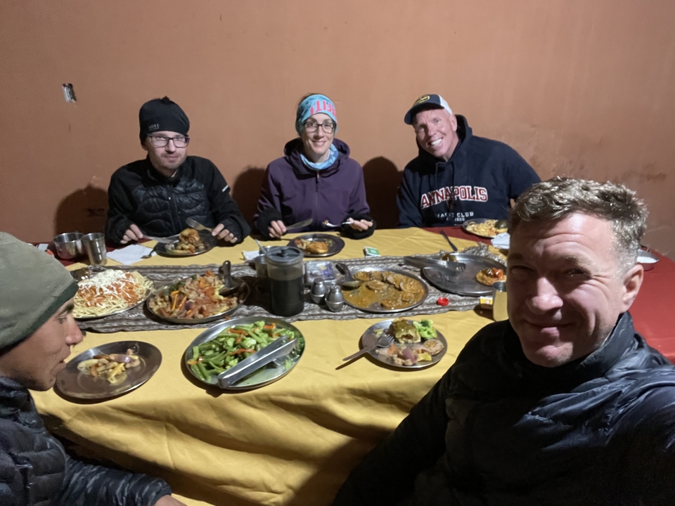 Group of people enjoying a meal at a table indoors.
