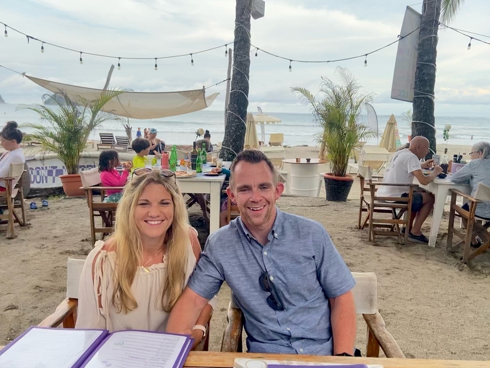 People dining at a beachside restaurant.