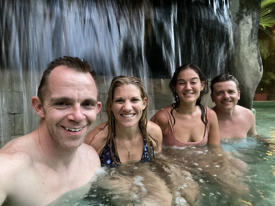 Group in a hot spring with waterfall.