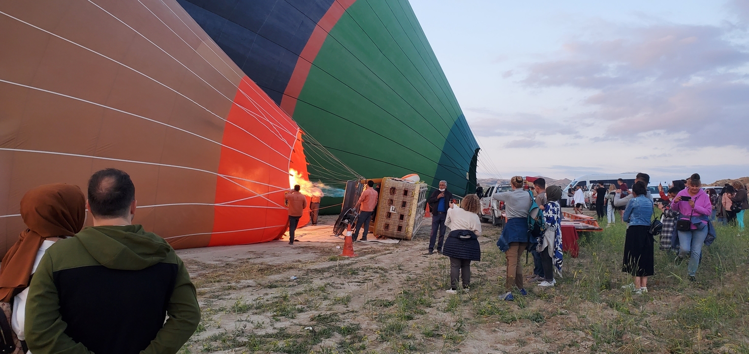 People preparing a hot air balloon for takeoff.