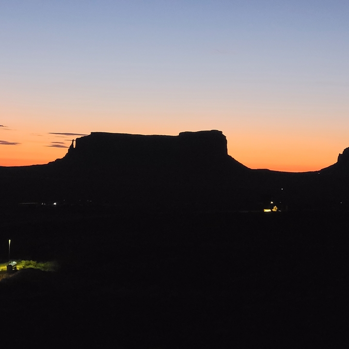 Silhouette of a mesa at sunset.