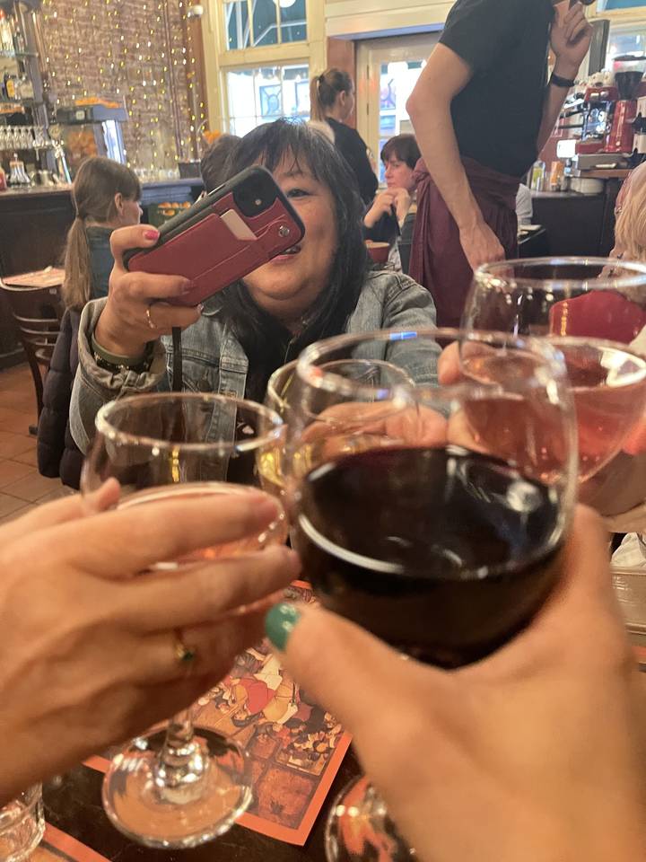 People in a restaurant making a toast with drinks.