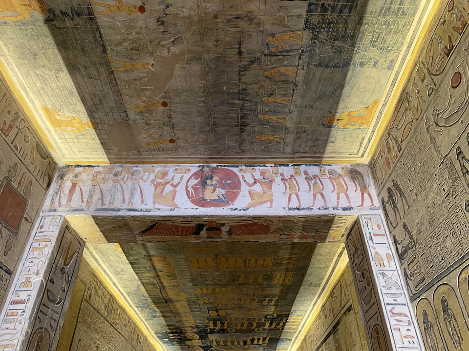Ceiling of an ancient tomb with vibrant paintings.