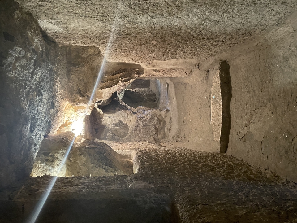 Dark cave-like interior with sculpted stone walls.