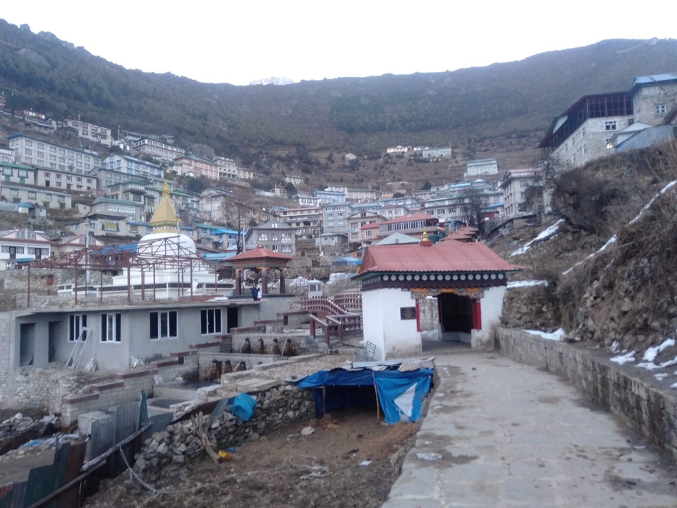 Small mountain village with numerous scattered buildings.