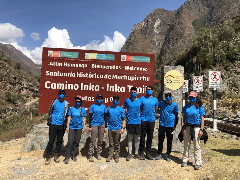 Group with matching shirts posing at the start of the Inca Trail.