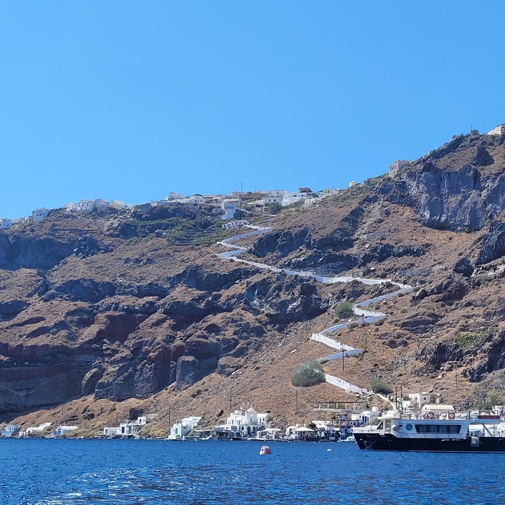 Hiking path zigzagging up a steep hillside.