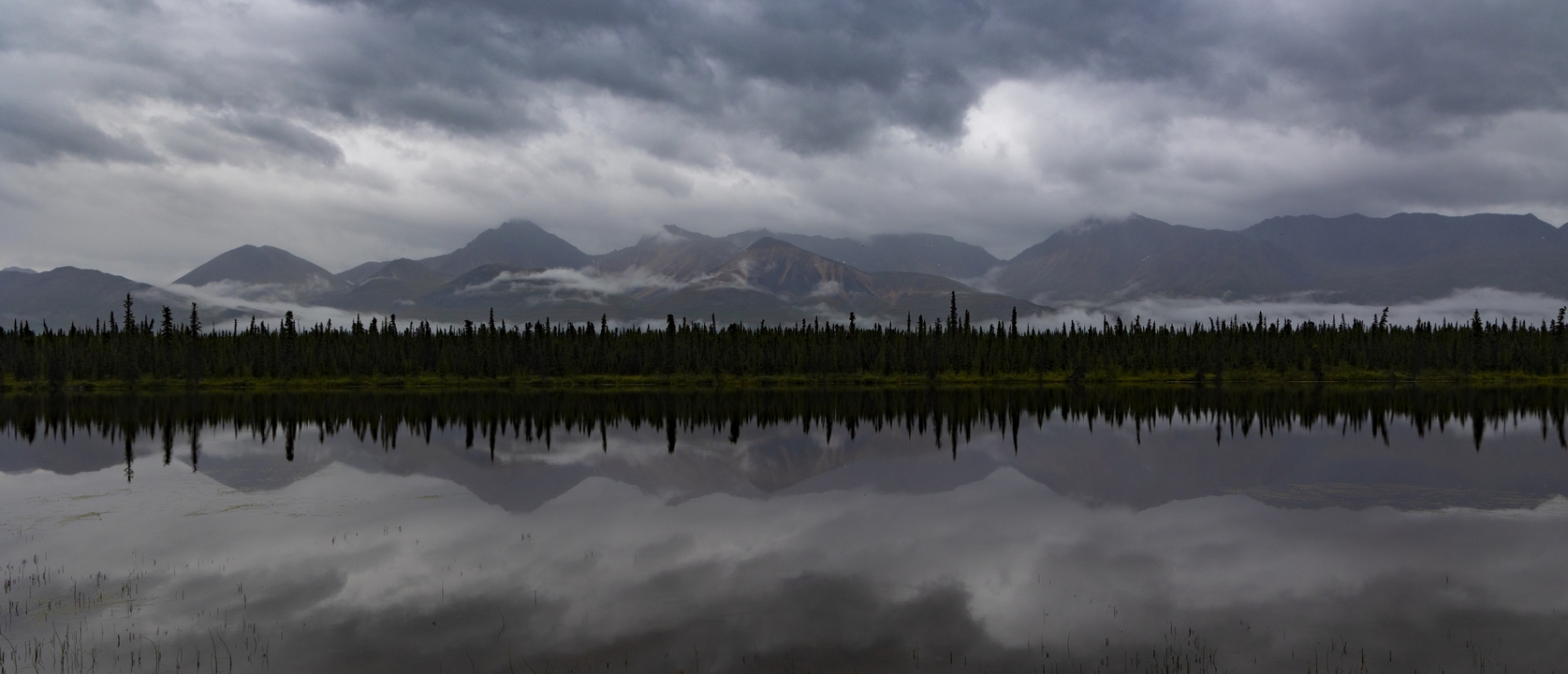 Mirror reflection of mountains on a lake.