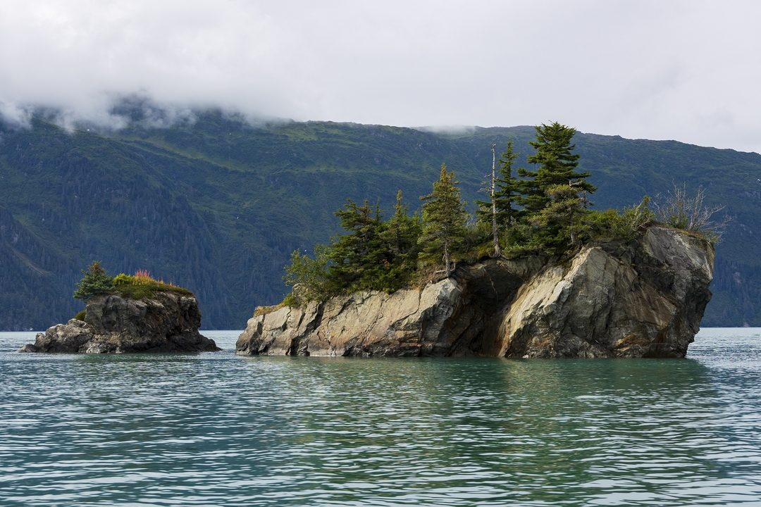 Rocky islets with trees on a lake.