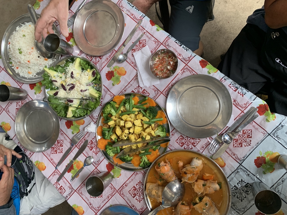 Table with various foods, including vegetables, stew, and salad.