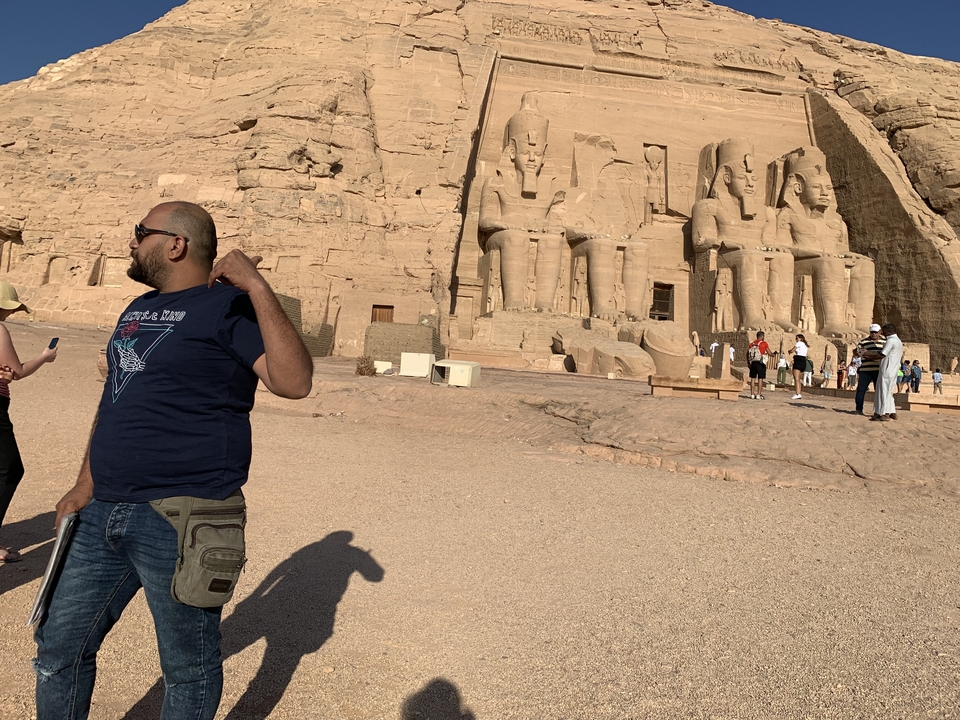 Group of statues carved into a rock face.