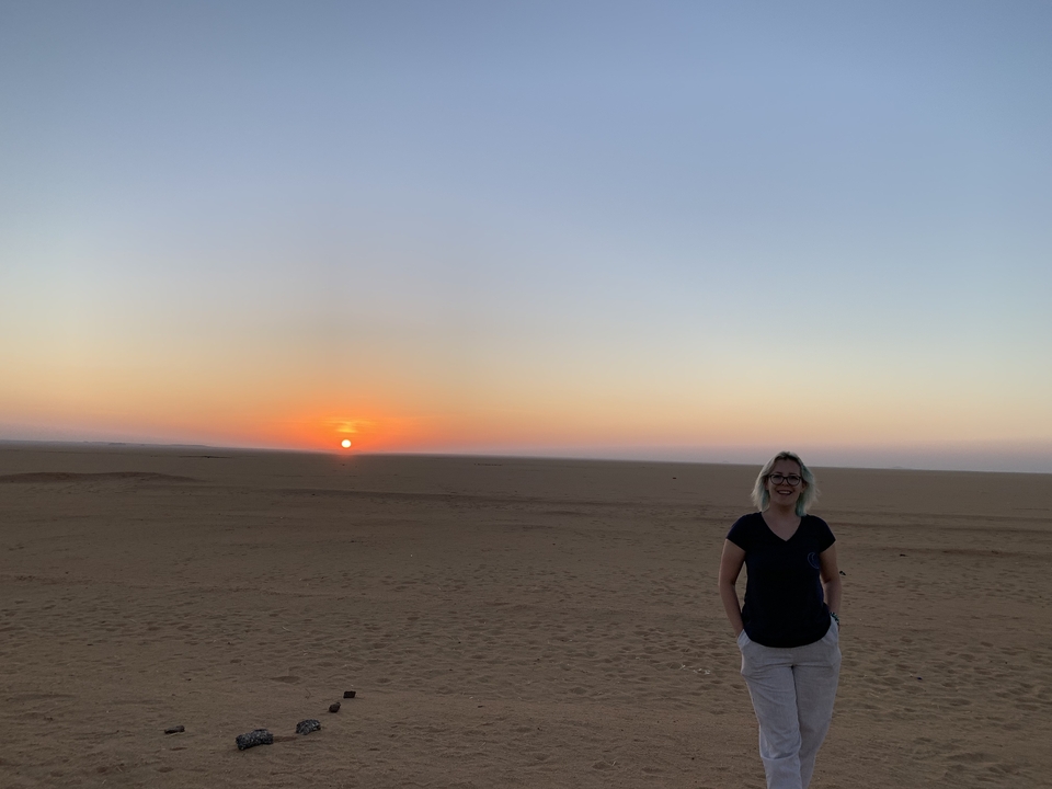 Person enjoying sunset in the desert.