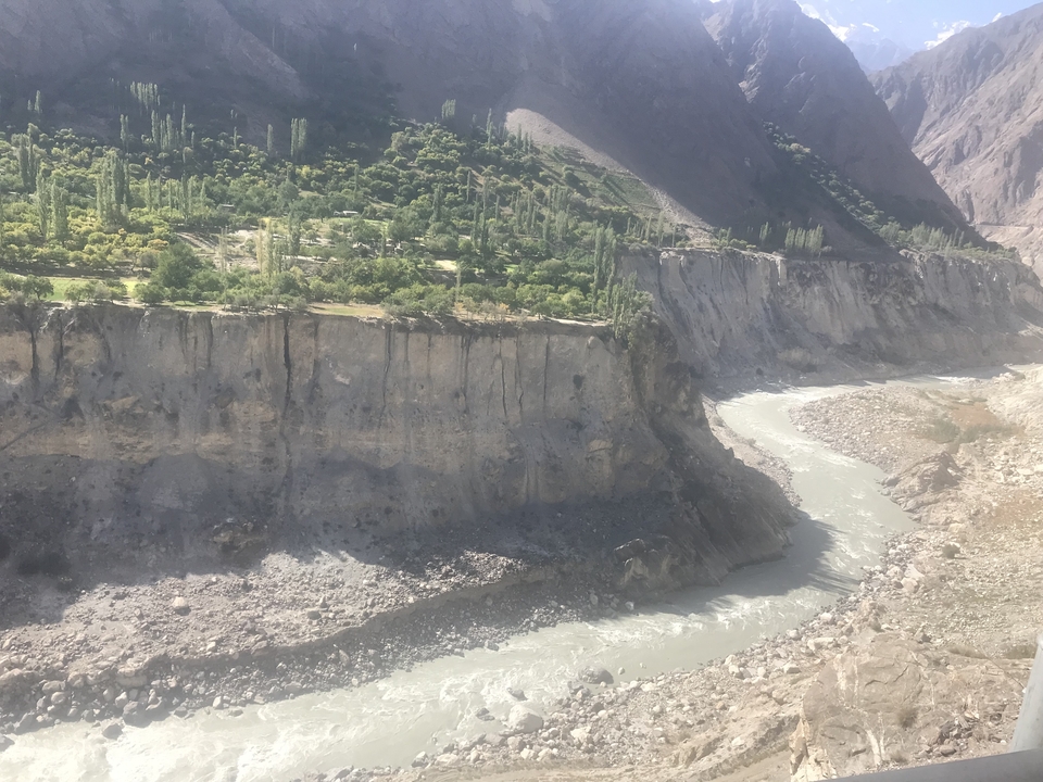 River running through a deep gorge with greenery on top.