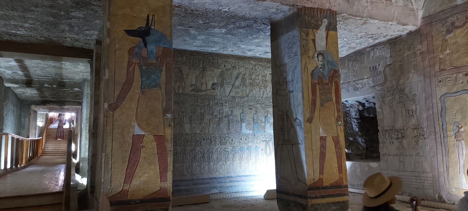 Interior of an ancient tomb with colorful wall paintings.