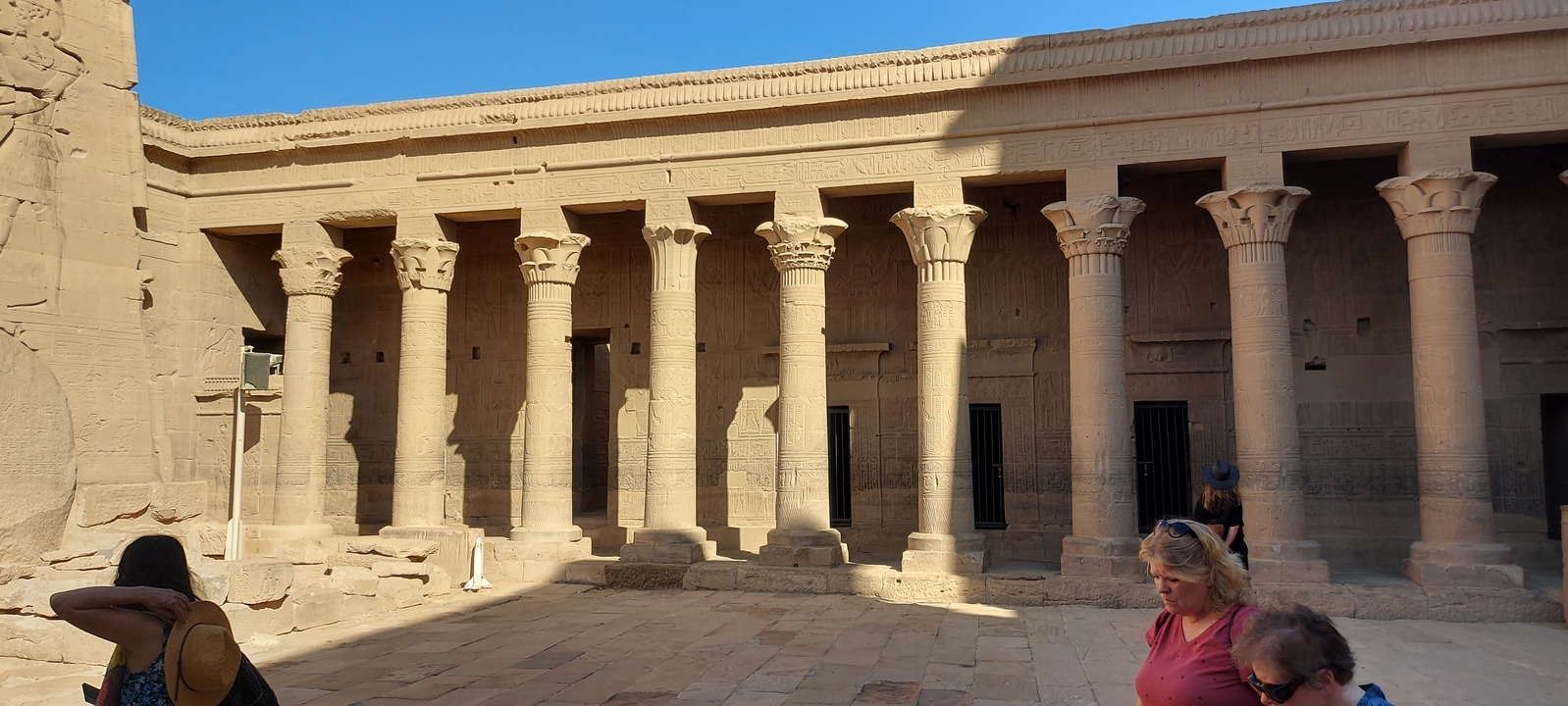 Interior of an ancient temple with columns and carvings.