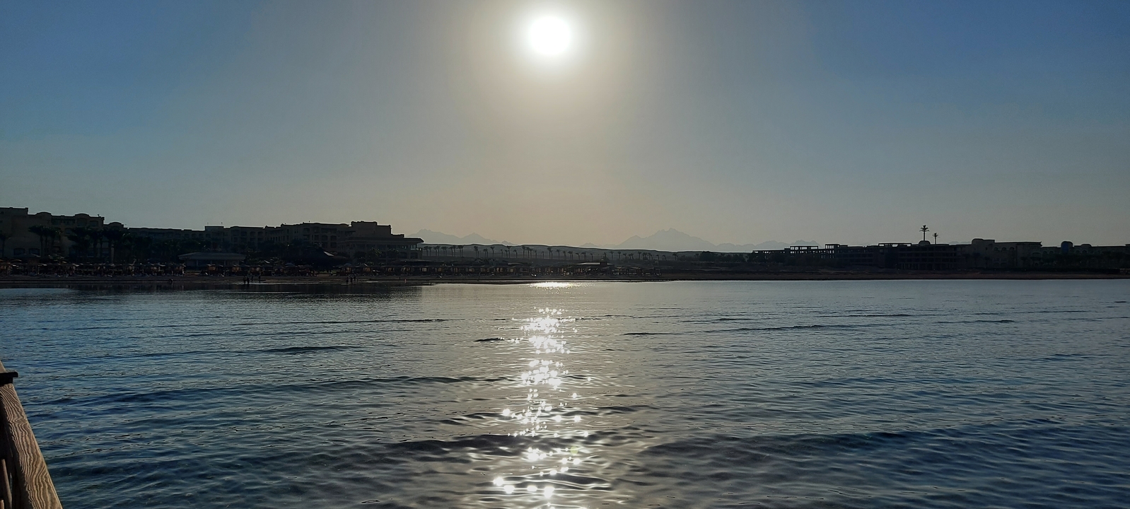 Expansive view of a beach and ocean with a skyline.