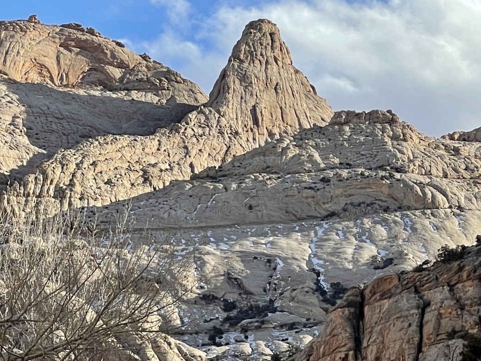 Majestic mountains with distinct peaks under a cloudy sky.