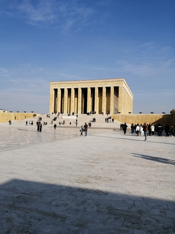 Monument with columns and stairs, people walking