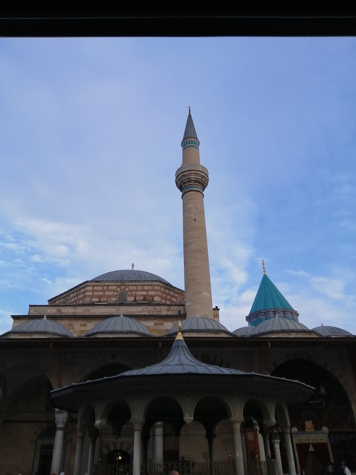 Minaret and domes of a mosque under a blue sky