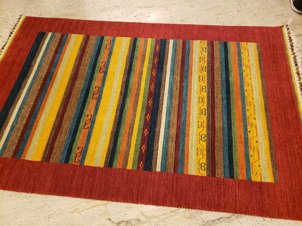 Colorful striped carpet with intricate patterns.