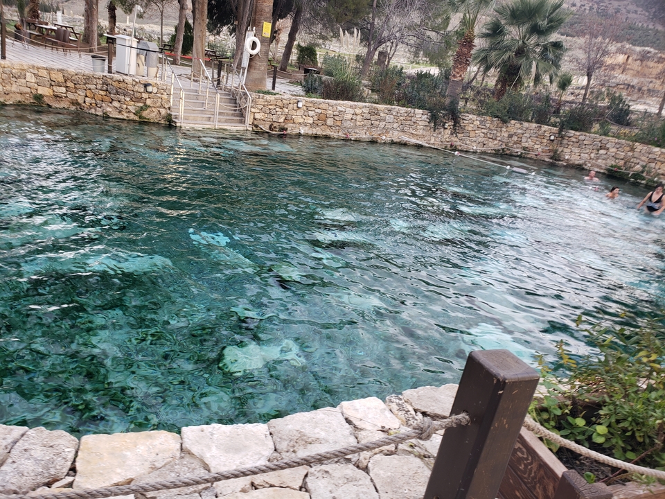 Natural swimming pool with people enjoying the water.