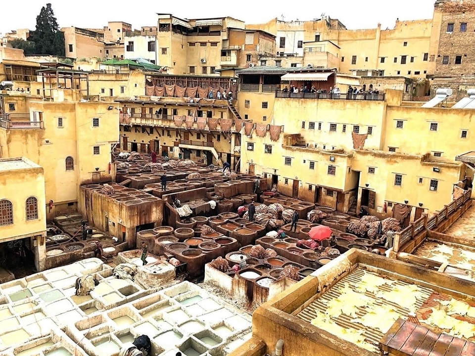 Traditional Moroccan tanneries with stone vats and colored hides.