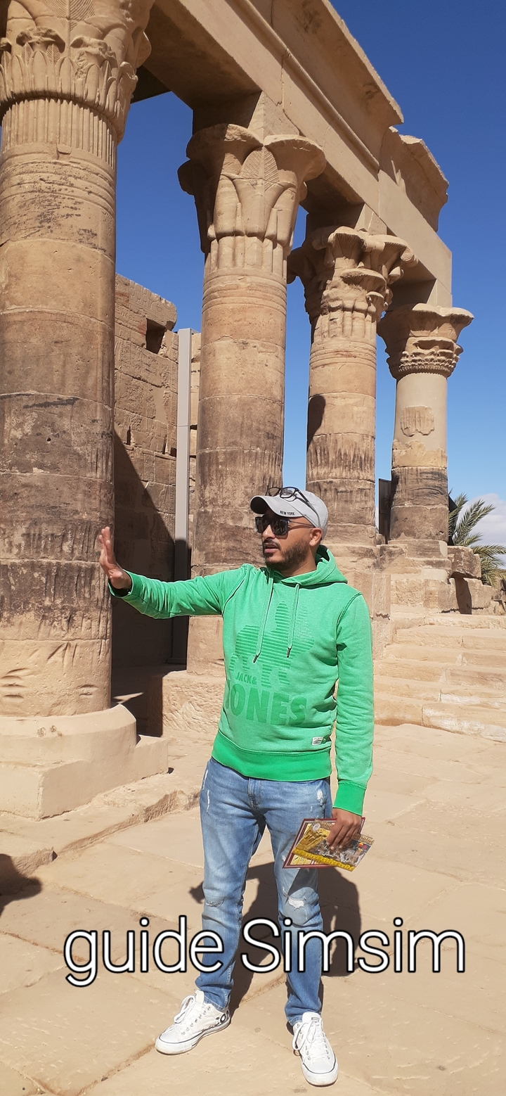 Tour guide explaining a site with ancient columns.