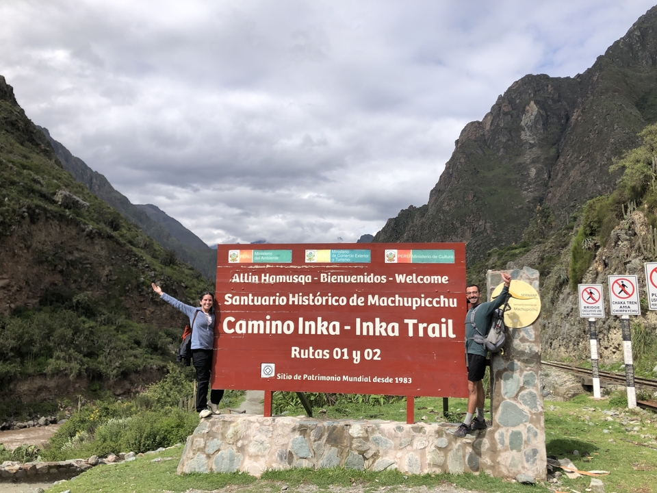 Two people posing in front of an Inka Trail sign.