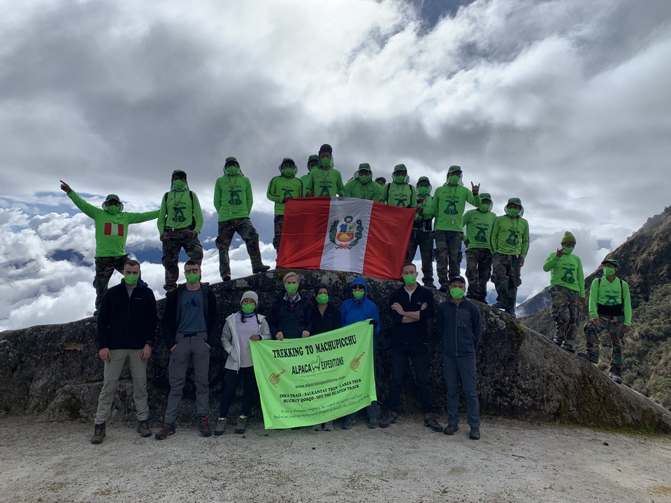 Group with a flag on a mountain trail.