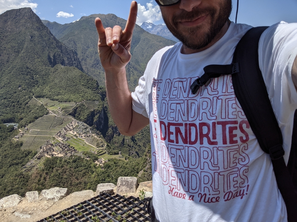 A person in hiking gear with Machu Picchu in the background.